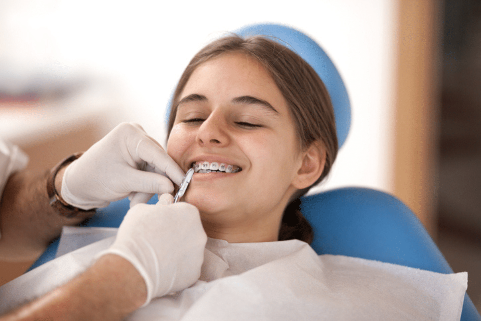 Orthodontist checking teen braces before summer break in Corona, CA